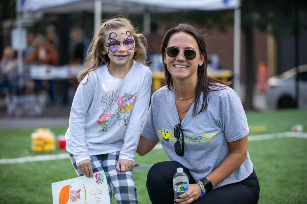 Power employee and child pose together for a photo at one of the company's annual charity events.