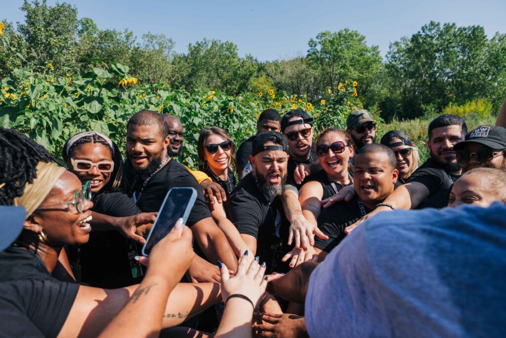 employees stacking hands before volunteer project