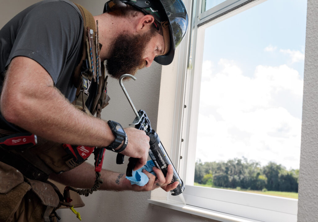 Caulk a window.