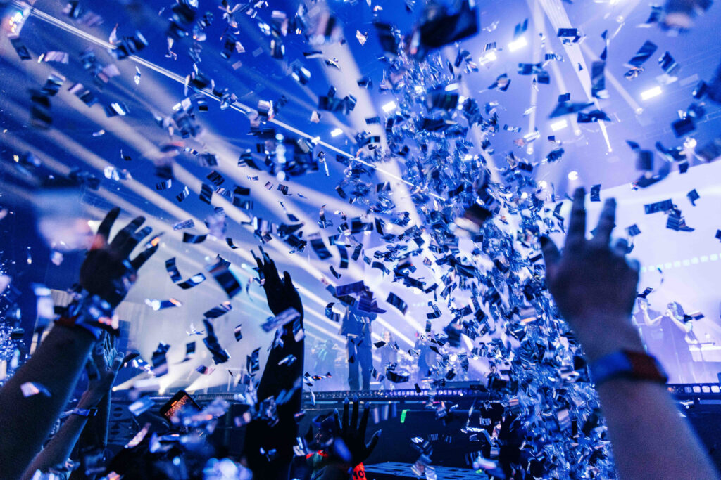 musician performing on stage to a crowd of people