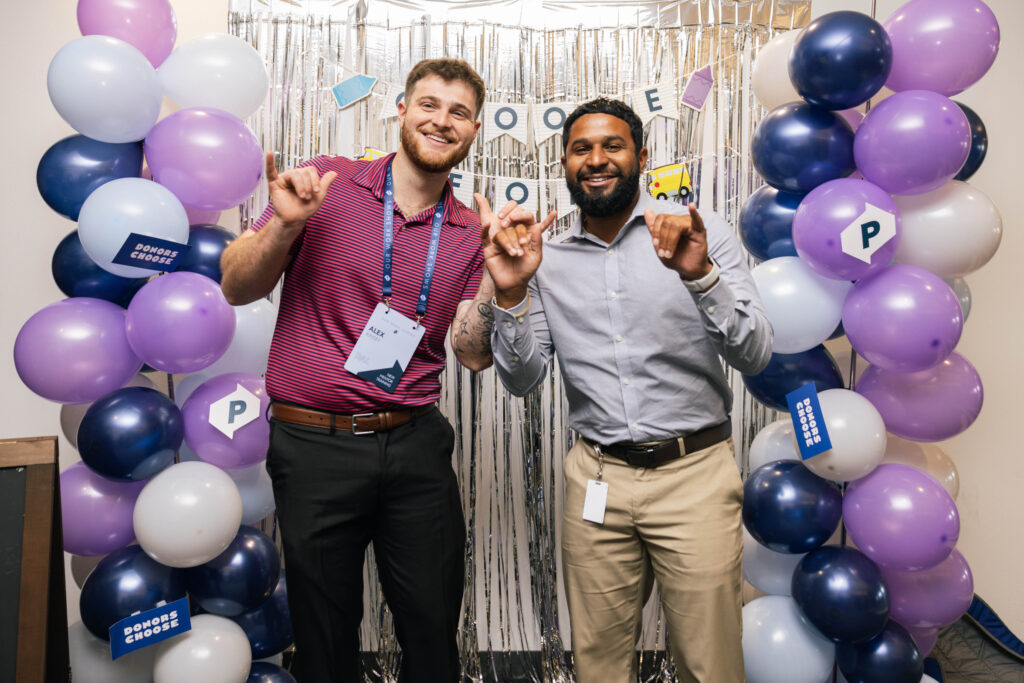 Employees interact at HQ celebration to support teachers.