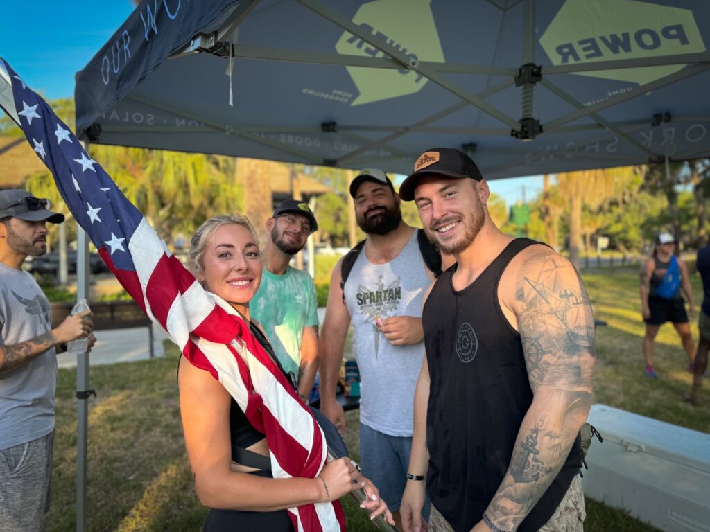 employees pose with american flag for Ruck March